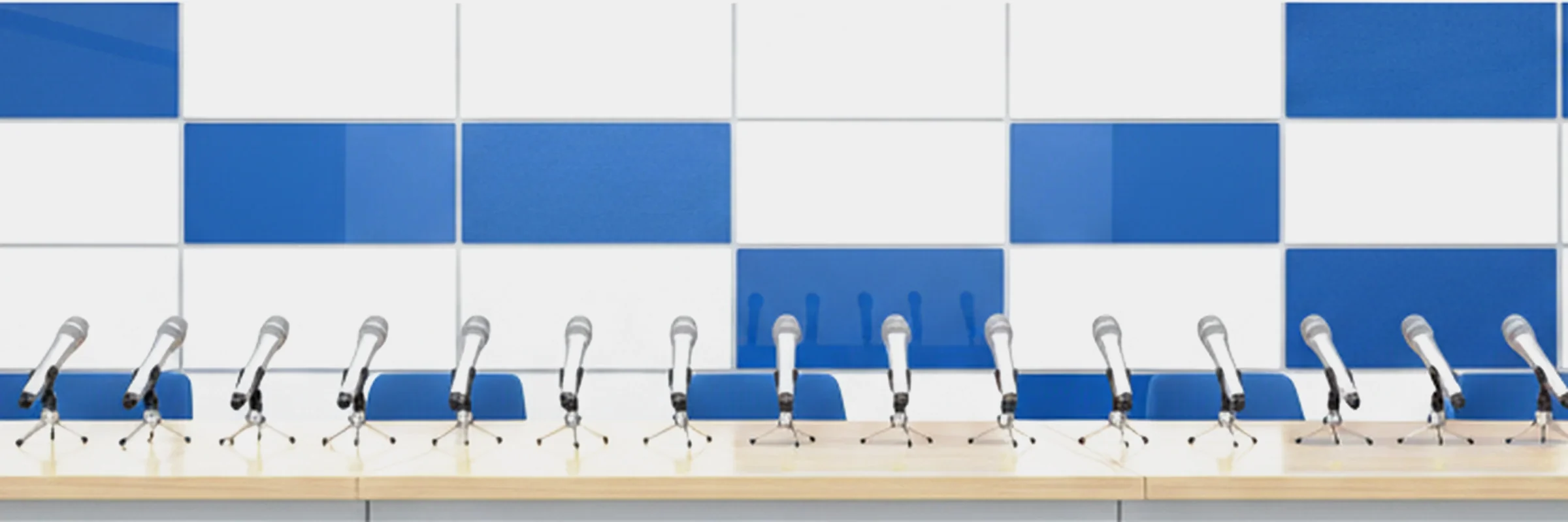Bright white and blue press conference backdrop with microphones